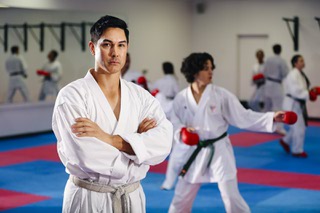Karate instructor/dojo owner Hiroshi Allen poses for a photo as students train during a class at Hiro Karate in Summerlin Monday, June 27, 2022.