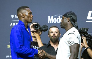 UFC middleweight champion Israel Adesanya, left, shakes hands with challenger Jared Cannonier during a UFC 276 news conference at T-Mobile Arena Thursday, June 30, 2022. UFC 276 takes place at the arena on Saturday.