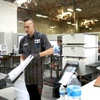 Photo: Election workers feed ballots into machines during