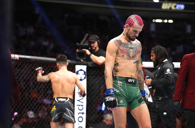 Bantamweight fighter Sean O’Malley, right, walks away from Pedro Munhoz after their bout ended in a “no contest” during UFC 276 at T-Mobile Arena Saturday July 2, 2022. The fight was stopped in the second round after Munoz was injured by an accidental eye poke.
