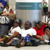 Alisson Bryan, Marcel Bryan and Terry Craig, wait to check-in their luggage for their flight home to Missouri at Miami International Airport, Saturday, July 2, 2022, in Miami. The group were on a cruise ship vacation in the Caribbean. The Fourth of July holiday weekend is jamming U.S. airports with the biggest crowds since the pandemic began in 2020.