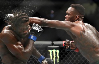 UFC middleweight champion Israel Adesanya punches Jared Cannonier during UFC 276 at T-Mobile Arena Saturday July 2, 2022.
