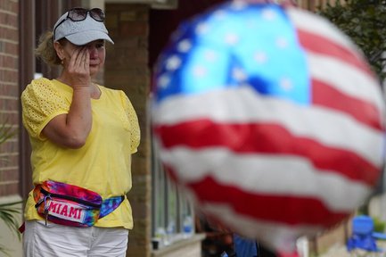 A woman wipes tears after a mass shooting at the Highland Park Fourth of July parade in Highland Park, Ill., a Chicago suburb, Monday, July 4, 2022. (AP Photo/Nam Y. Huh)

