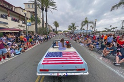 Actress Scarlett Abinante heads up Main Street during the 118th Huntington Beach 4th of July Parade in Huntington Beach, Calif., on Monday, July 4, 2022. (Jeff Gritchen/The Orange County Register via AP)


