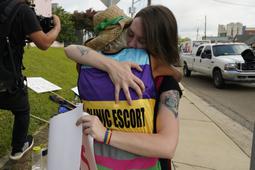 Derenda Hancock, co-director of the Jackson Women's Health Organization clinic patient escorts, better known as the Pink House defenders, left, hugs a tearful abortion rights supporter Sonnie Bane, outside the Jackson Women's Health Organization clinic in Jackson, Miss., Wednesday, July 6, 2022. The clinic is the only facility that performs abortions in the state. However, on Tuesday, a chancery judge rejected a request by the clinic to temporarily block a state law banning most abortions. Without other developments in the Mississippi lawsuit, the clinic will close at the end of business Wednesday and the state law will take effect Thursday. 


