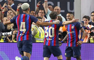 Barcelona's Raphael Dias (22), right, celebrates with teammates Ronald Araujo (4) and Pablo Paez Gavira (30) after scoring in the first half of a preseason soccer game between Real Madrid and Barcelona at Allegiant Stadium Saturday, July 23, 2022.