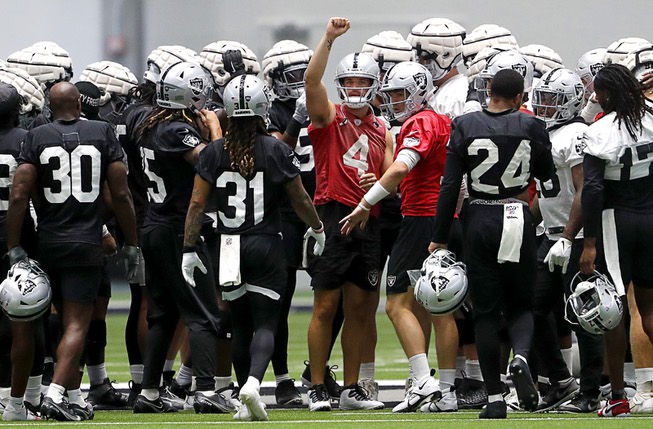 Las Vegas Raiders quarterback Derek Carr (4) gathers the team together during NFL football training camp Saturday, July 30, 2022, in Henderson, Nev.