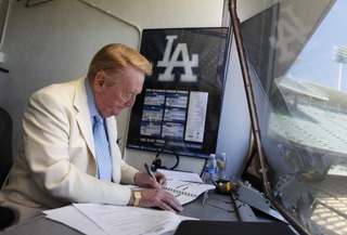 Vin Scully works in his booth at Dodger Stadium in Los Angeles on Aug. 22, 2010. Scully, whose dulcet tones provided the soundtrack of summer while entertaining and informing Dodgers fans in Brooklyn and Los Angeles for 67 years, died Tuesday night, Aug. 2, 2022, the team said. He was 94. =

