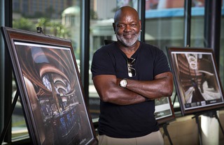 Pro Football Hall of Famer Emmitt Smith poses by artist renderings of his restaurant at the Fashion Show Mall Thursday, Aug. 18, 2022. Emmitts Las Vegas, a 30,000+ sq. ft. restaurant and event venue, is expected to open at the mall near the end of 2022 of early 2023.