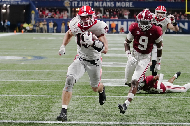 Georgia tight end Brock Bowers (19) runs into the end zone for a touchdown against Alabama defensive back Jordan Battle (9) during the second half of the Southeastern Conference championship NCAA college football game, Saturday, Dec. 4, 2021, in Atlanta. Bowers was named to The Associated Press preseason All-America team, Monday, Aug. 22, 2022.