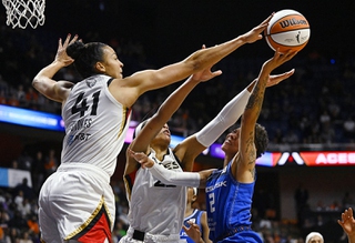 Las Vegas Aces' Kiah Stokes, left, blocks a shot attempt by Connecticut Sun's Natisha Hiedeman as Aces' A'ja Wilson, center, defends during the first half in Game 3 of basketball's WNBA Finals, Thursday, Sept. 15, 2022, in Uncasville, Conn.
