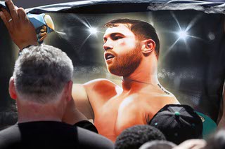 A fan holds up an image of undisputed super middleweight champion Canelo Alvarez as people wait for the official weigh-in at Toshiba Plaza Friday, Sept. 16, 2022. Alvarez is scheduled to defend his titles against Gennadiy Golovkin when they meet for the third time on Saturday at T-Mobile Arena.