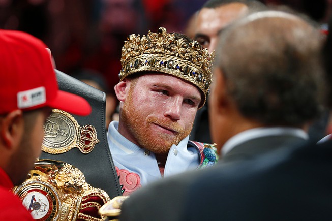 Undisputed super middleweight champion Canelo Alvarez puts on his belts ...