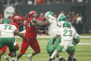 UNLV defensive lineman Darius Johnson (8) holds back North Texas offensive lineman Febechi Nwaiwu (54) during a play in the second half of their game at Allegiant Stadium Saturday Sept. 17, 2022. UNLV beat North Texas 58-27.