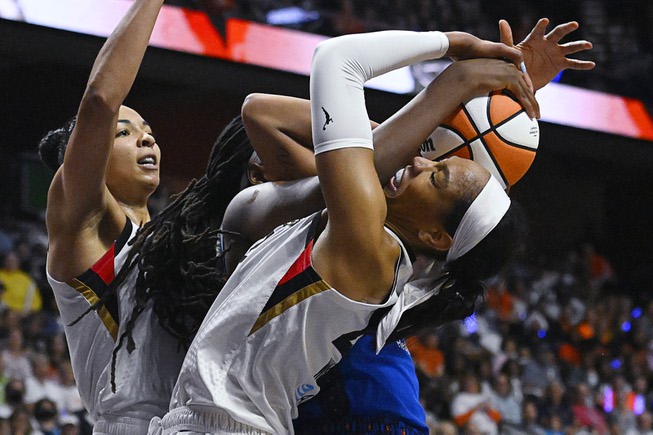Las Vegas Aces' A'ja Wilson, right, fights for a rebound ...