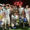 The Green Valley defensive line takes a picture with the Henderson Bowl after beating rival Basic 24-10 on Sept. 22, 2022. 