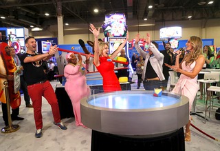 Local television personality JJ Snyder, center, reacts as she wins $10,000 for her charity of choice during Lets Make a Deal Winfall game in the IGT booth during the Global Gaming Expo (G2E) in the Venetian Expo Tuesday, Oct. 11, 2022. Snyder will donate the money to Win Win Entertainment, a charity that arranges celebrity visits to children in hospitals, she said.