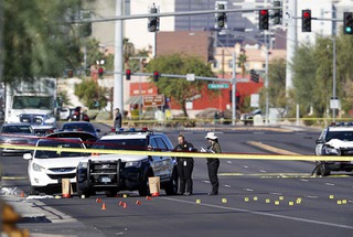 Metro Police crime scene analysts work at the scene of fatal shooting, Metro Officer Truong Thai, 49, was killed, on East Flamingo Road, near the UNLV campus Thursday, Oct. 13, 2022. 