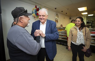 Nevada Governor Steve Sisolak, center, talks with Misael Romero, owner of Panaderia Y Pasteleria Latina during a visit to the pastry shop Tuesday, Oct. 25, 2022. Assemblywoman Selena Torres, right, accompanied the governor on the visit.