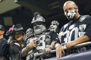 Las Vegas Raiders fans pose for photo before an NFL football game against the New Orleans Saints Sunday, Oct. 30, 2022, in New Orleans.
