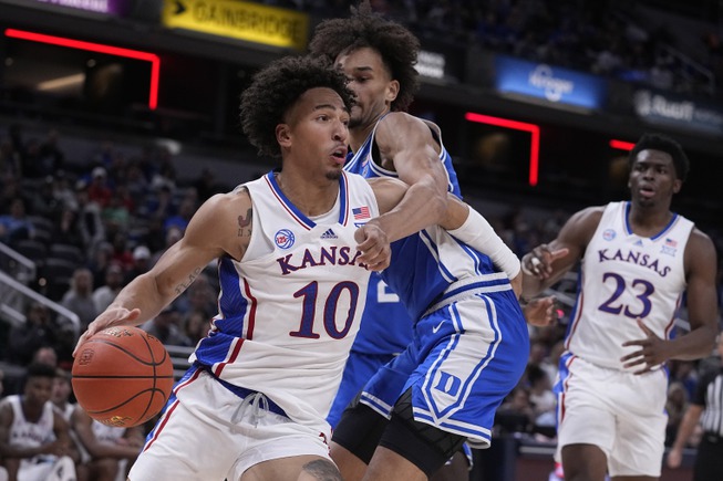 Kansas forward Jalen Wilson (10) drives around Duke guard Tyrese Proctor, center, during the second half of an NCAA college basketball game, Tuesday, Nov. 15, 2022, in Indianapolis. 

