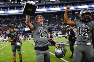 Silverado Skyhawks quarterback Brandon Tunnell (11) holds up a 4A state title trophy after his team defeats the Shadow Ridge Mustangs, 51-27, during a game at Allegiant Stadium Monday, Nov. 21, 2022.