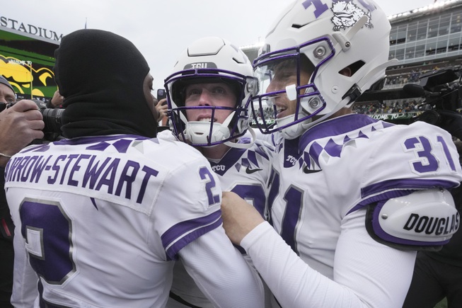 TCU place kicker Griffin Kell, center, celebrates with teammates Jordy Sandy (31) and Kee'Yon Stewart after Kell scored a field goal in the final seconds of an NCAA college football game against Baylor in Waco, Texas, Saturday, Nov. 19, 2022. TCU won 29-28.