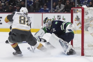 Vancouver Canucks goalie Thatcher Demko, right, stops Vegas Golden Knights' Jonathan Marchessault during first-period NHL hockey game action in Vancouver, British Columbia, Monday, Nov. 21, 2022.


