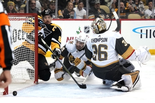 Pittsburgh Penguins' Sidney Crosby tiffs on a loose puck behind Vegas Golden Knights goaltender Logan Thompson with Nicolas Hague (14) defending during the second period in Pittsburgh, Thursday, Dec. 1, 2022. 


