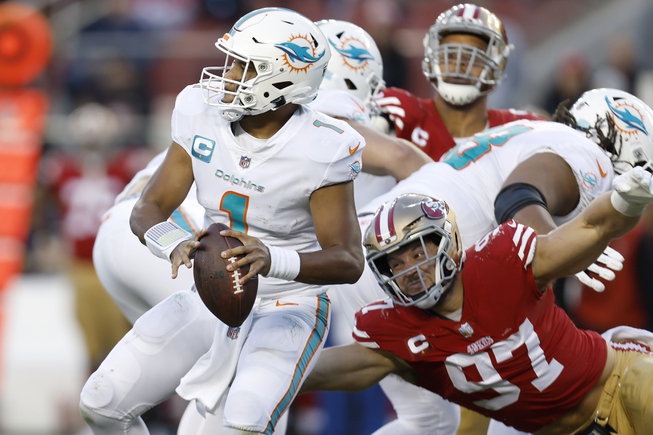 Miami Dolphins quarterback Tua Tagovailoa looks to pass before San Francisco 49ers defensive end Nick Bosa (97) caused Tagovailoa to fumble, which 49ers linebacker Dre Greenlaw returned for a touchdown, during the second half of an NFL football game in Santa Clara, Calif., Sunday, Dec. 4, 2022. 


