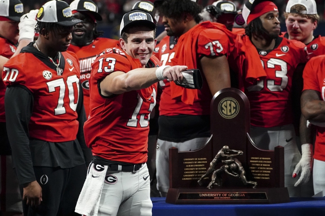 Georgia quarterback Stetson Bennett (13) gestures to the crowd during the trophy presentation the Southeastern Conference Championship football game Saturday, Dec. 3, 2022 in Atlanta. 


