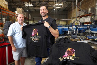 Mario Stadtlander, president left, and Sean Ono, CEO, pose on the shop floor at Eagle Promotions, a custom apparel and promotional items company, Friday, Dec. 16, 2022. The company is one of the local companies accepted in the NFL Business Connect program.