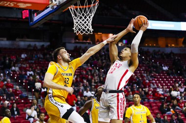 UNLV Rebels center David Muoka (12) puts the ball up as Southern Miss Golden Eagles forward Felipe Haase (22) guards him during a game at the Thomas & Mack Center Thursday, Dec. 22, 2022.