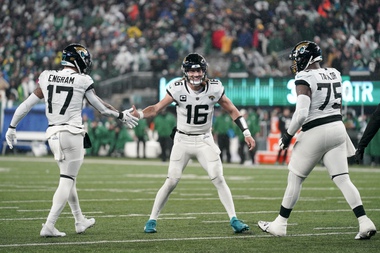 Jacksonville Jaguars quarterback Trevor Lawrence (16) celebrates with tight end Evan Engram (17) and offensive tackle Jawaan Taylor (75) after scoring a touchdown against the New York Jets during the second quarter of an NFL football game, Thursday, Dec. 22, 2022, in East Rutherford, N.J. 


