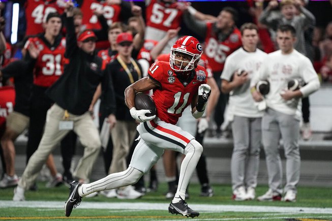 Georgia wide receiver Arian Smith (11) runs for the end zone for a touchdown against Ohio State during the second half of the Peach Bowl NCAA college football semifinal playoff game, Saturday, Dec. 31, 2022, in Atlanta. 

