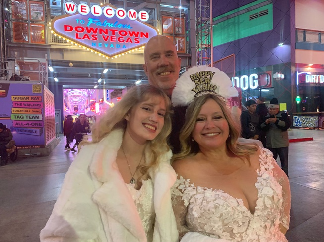 Curtis and Heidi Dawson of Orange County, Calif, join the New Year's Eve festivities at Fremont Street Experience on Dec. 31, 2022. Earlier, they renewed their wedding vows after 20 years of marriage. They are pictured with daughter, Katie.

