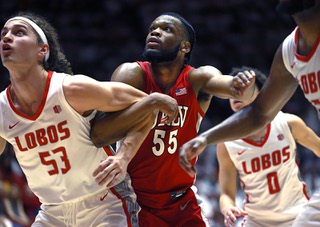UNLV's Elijah Harkless, center, and New Mexico's Josiah Allick, wait for a rebound during the second half of an NCAA college basketball game against New Mexico, Saturday, Jan. 7, 2023, in Albuquerque, N.M. UNLV won 84-77.