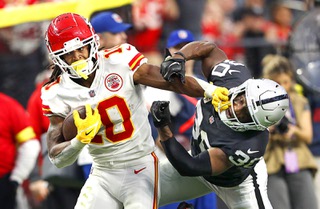 Kansas City Chiefs running back Isiah Pacheco (10) fends off a tackle by Las Vegas Raiders safety Duron Harmon (30) during the second half of an NFL football game at Allegiant Stadium Sunday, Jan. 1, 2023.