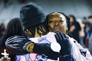 Twayne Hughes receives a hug from a mourner during a candlelight vigil for her daughter Ashari Hughes at Desert Oasis High School Jan. 11, 2023. Hughes, a 16-year-old sophomore died following her flag football game on Jan. 5, 2023.