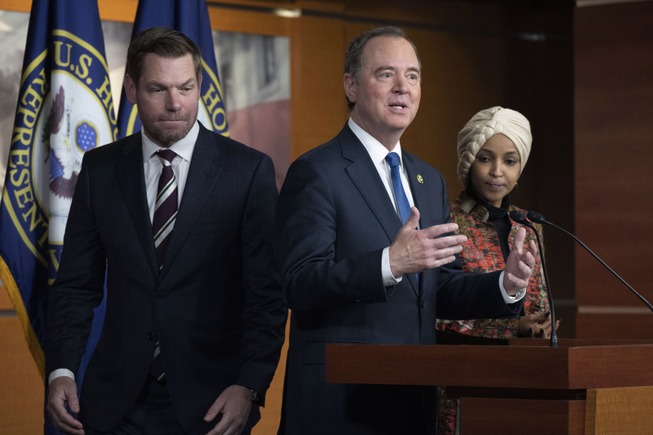 Rep. Adam Schiff, D-Calif., center, with Rep. Eric Swalwell, D-Calif., left, and Rep. Ilhan Omar, D-Minn., speaks during a news conference on Capitol Hill in Washington, Wednesday, Jan. 25, 2023. Minority Leader Hakeem Jeffries of N.Y., has nominated the two California lawmakers for the Intelligence Committee in open defiance of House Speaker Kevin McCarthy's vow to block them. Jeffries asked that Schiff and Swalwell be reappointed to the Intelligence panel. 

