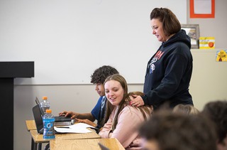 Principal Melinda Jeffrey visits with students during an English class at Tonopah High School in Tonopah, Nev. Thursday, Jan. 26, 2022. The class is taught by a remote teacher due to staffing shortages.