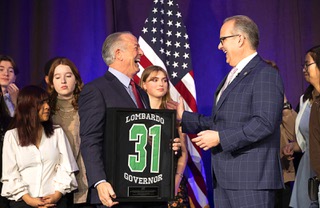 Clark County Superintendent Jesus Jara, right, laughs with Nevada Governor Joe Lombardo after Lombardo was presented with Rancho High School jersey by the School Board Student Advisory Council during the 2023 State of the Schools address at Resorts World Las Vegas, Friday, Jan. 27, 2023. Lombardo, the 31st governor of Nevada, graduated from Rancho High School in 1980. The Nevada Board of Education is considering pushing back the start time for schools across the state.