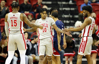 UNLV Rebels guard Keshon Gilbert (10) is congratulated by teammates Luis Rodriguez (15) and EJ Harkless (55) after making a basket and drawing a foul during the first half of an NCAA basketball game against the Fresno State Bulldogs Friday, Feb. 3, 2023, in Las Vegas.