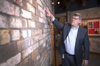 Geoff Schumacher, vice president of exhibits and programs at the Mob Museum, the National Museum of Organized Crime and Law Enforcement, looks over a section of the St. Valentine's Day Massacre wall the Mob Museum in downtown Las Vegas Friday, Feb. 10, 2023.