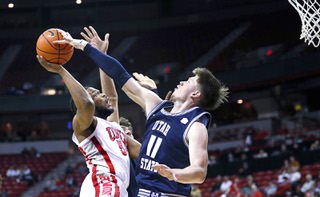 UNLV guard EJ Harkless (55) has his shot blocked by Utah State guard Max Shulga (11) during the second half of an NCAA college basketball game Wednesday, March 1, 2023, in Las Vegas.