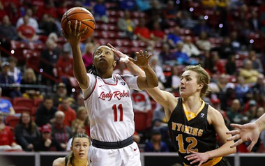 UNLV Lady Rebels guard Justice Ethridge (11) shoots a layup by Wyoming Cowgirls guard Malene Pedersen (12) during the second half of the Mountain West tournament championship game at the Thomas & Mack Center Wednesday, March 8, 2023.