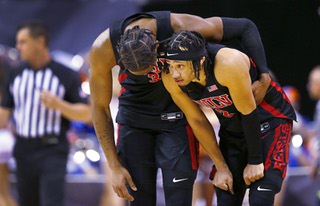 UNLV guard Shane Nowell, left, talks with Justin Webster (2) after the Rebels 87-76 overtime loss to Boise State in the Mountain West tournament Thursday, March 9, 2023, in Las Vegas.