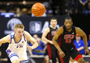 Boise State guard Jace Whiting (15) and UNLV guard EJ Harkless (55) chase after a loose ball in the second half of an NCAA college basketball game during the Mountain West tournament Thursday, March 9, 2023, in Las Vegas.