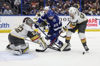 Vegas Golden Knights' Shea Theodore (27) checks Tampa Bay Lightning's Michael Eyssimont (23) in front of goaltender Jonathan Quick during the second period Thursday, March 9, 2023, in Tampa, Fla. 


