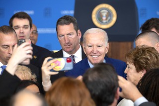 President Joe Biden, center, poses for photos after speaking on prescription drug costs during an event at UNLV Wednesday, March 15, 2023.